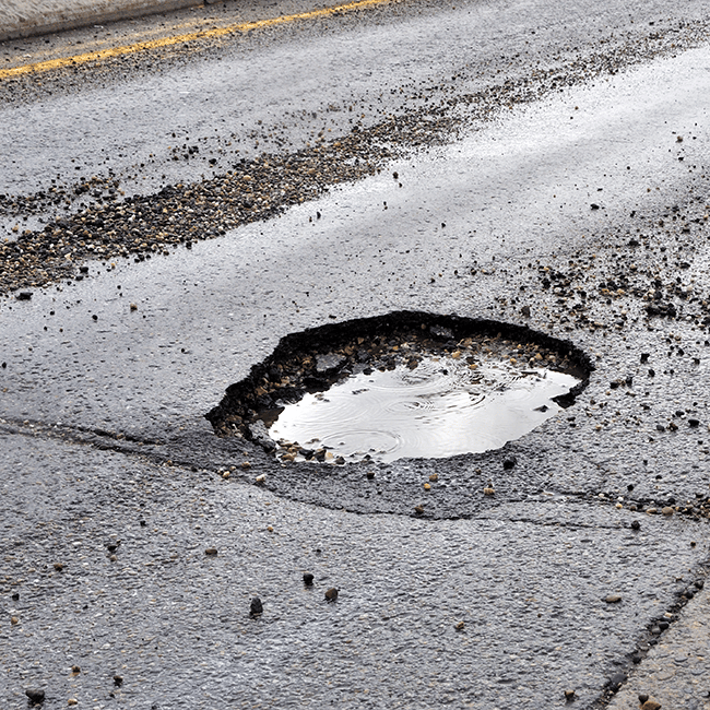 pot hole can damage your vehicles suspension Shadetree Automotive
